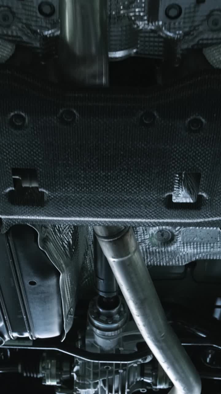Underside View of Car Exhaust System and Drivetrain Components