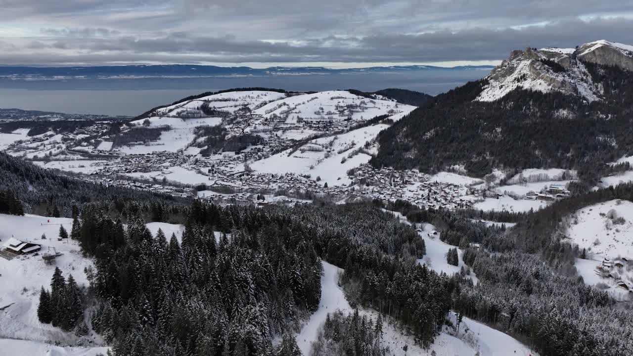 Snow valley with mountains, pines and lake Léman, Bernex