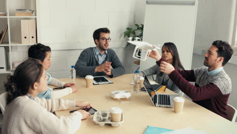 group of young hipsters discussing drone technology