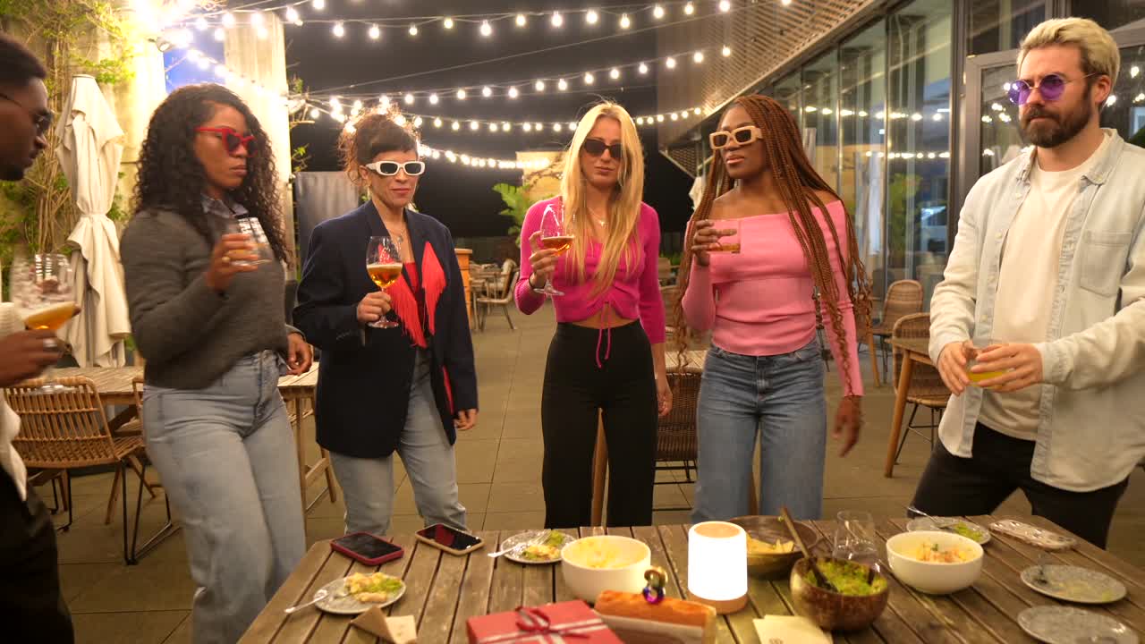 Friends celebrating and toasting at an outdoor dinner party