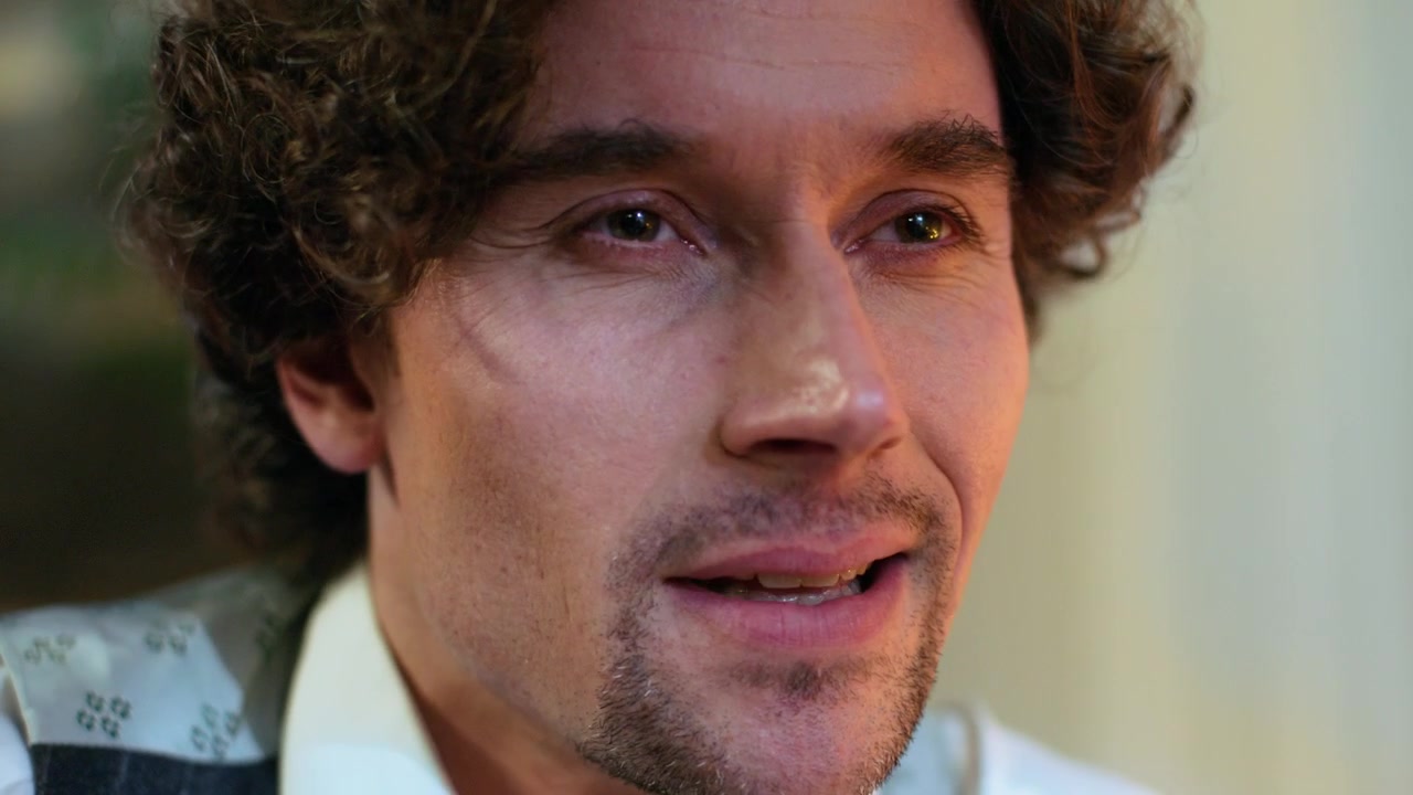 Close-up Portrait of a Man with Curly Hair Talking
