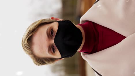 Woman-Wearing-Reusable-Protective-Mask-in-Winter.health,-safety-and-pandemic-concept-–-young-woman-wearing-black-face-protective-reusable-barrier-mask-outdoors-over-snow-in-winter