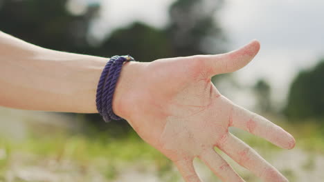 smooth relaxing meditation sand pouring man guy hands wrist open dust falling out day at the beach adventure hour glass dry nature close up calm yoga carpe diem bracelet hot summer european dessert