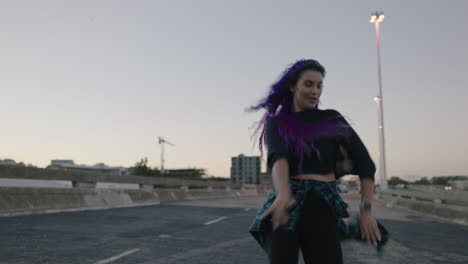 dancing woman beautiful street dancer with colorful hair performing contemporary hip hop moves enjoying modern dance expression in city at sunset