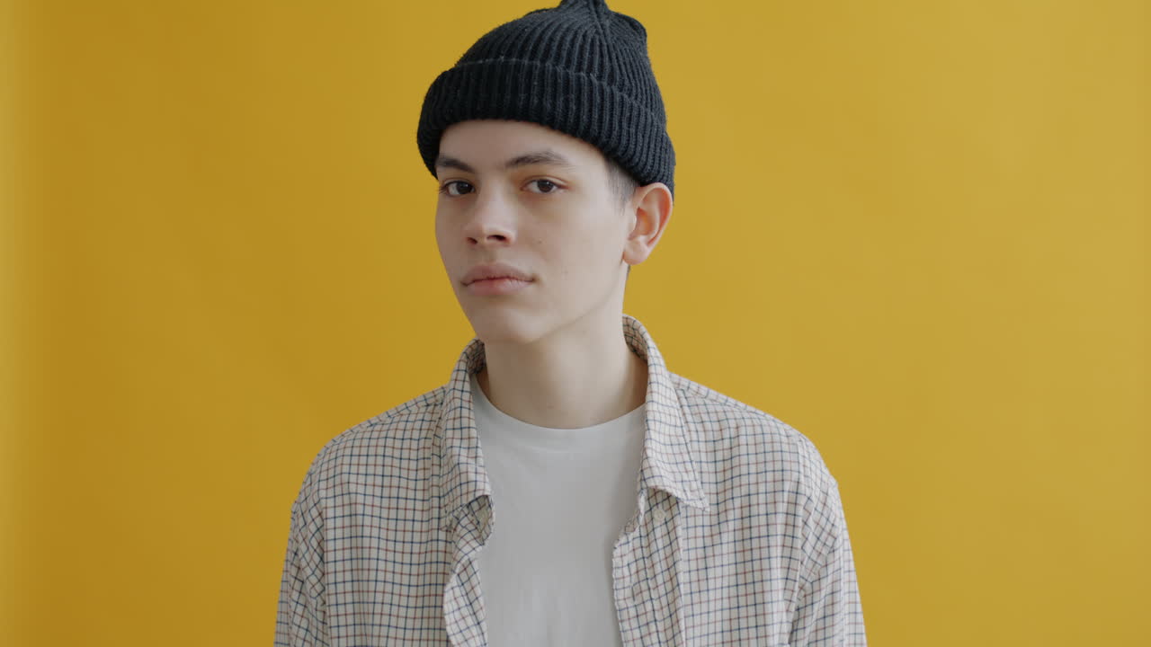 Young Man in a Beanie and Checked Shirt