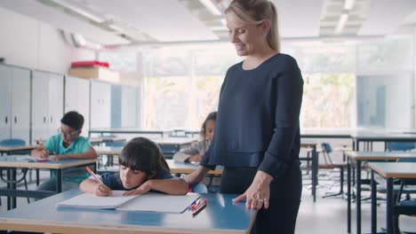 young female school teacher checking task