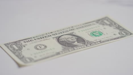 close up currency shot of hand grabbing us 1 dollar bill on marble background 2