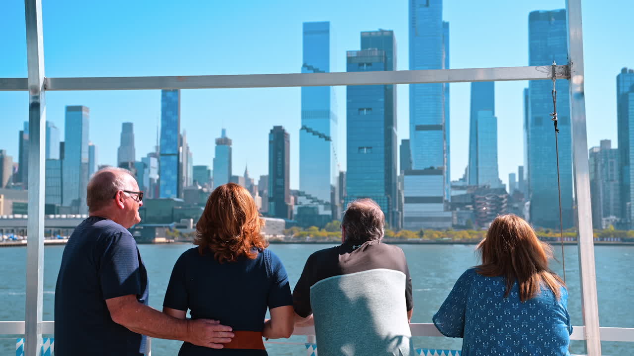 New York, USA, 9 August 2025: People on boat watching Manhattan skyline on sunny day. Passengers on a sightseeing boat looking at the modern Manhattan skyline across the Hudson River on a bright sunny day