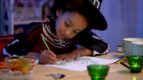 little girl coloring halloween drawing