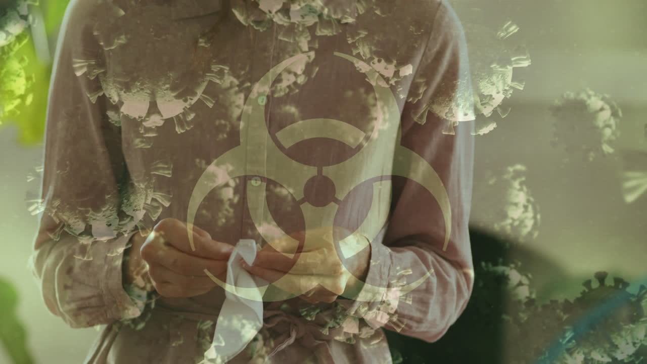 animación de las células de covid-19 sobre una persona cosiendo una máscara facial