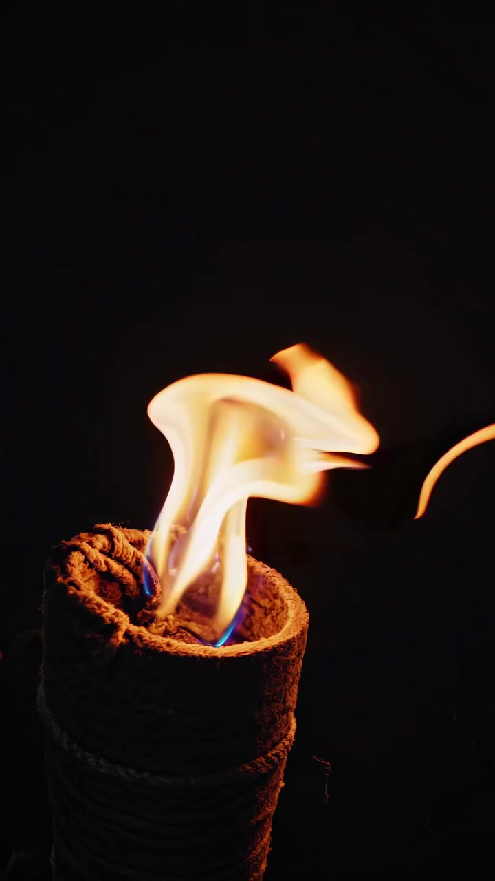 Close-Up of a Tiki Torch Flame Burning in the Dark