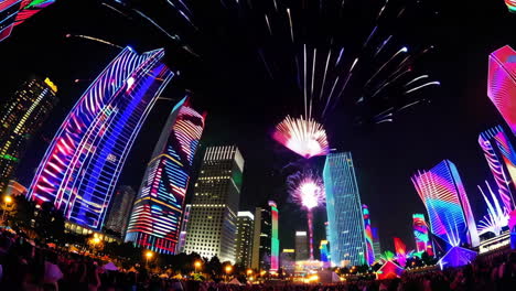 city fireworks display with illuminated buildings