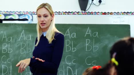 teacher teaching school kids in classroom