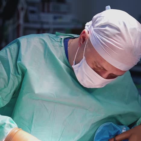 concentrated doctor performing a plastic surgery. professional surgeon doing a medical procedure to a patient with the help of assistant in clinic