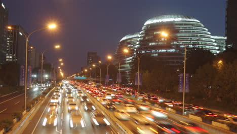 urban traffic time-lapse photography, where city vehicles quickly travel on the road at night, illuminating the entire city with lights