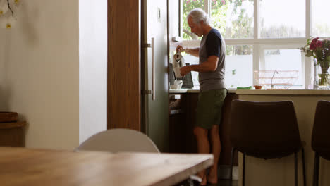 Senior-man-preparing-coffee-in-kitchen-4k