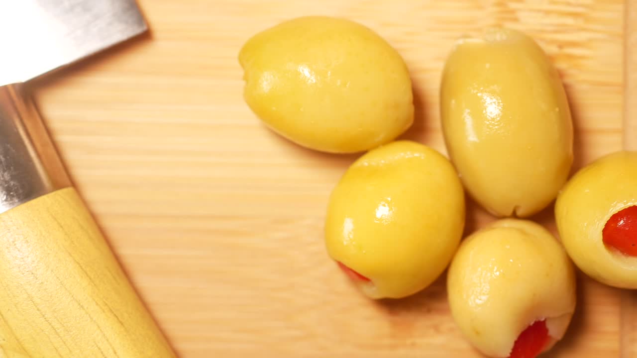 Stuffed Green Olives on a Wooden Cutting Board