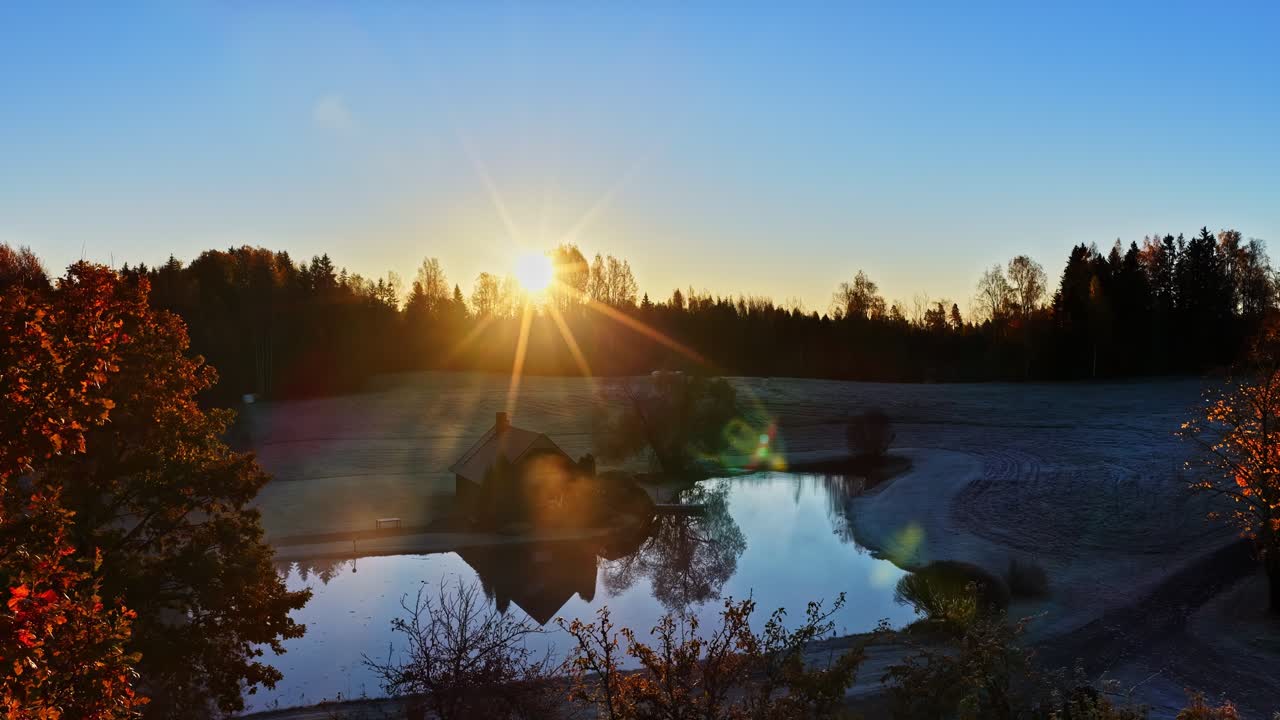 Sunrise with mist through autumn trees, peaceful and serene landscape