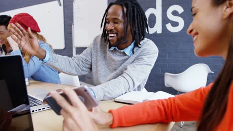 male and female executive interacting with each other while working together