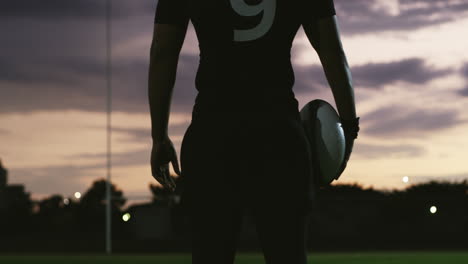 a young rugby player holding a rugby ball