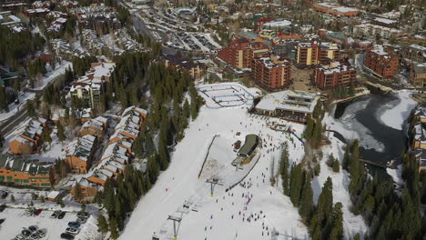 aerial drone footage of the quicksilver super chairlift along with skiers and snowboarders in breckenridge, colorado