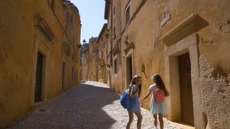 two young girls exploring a historic european town