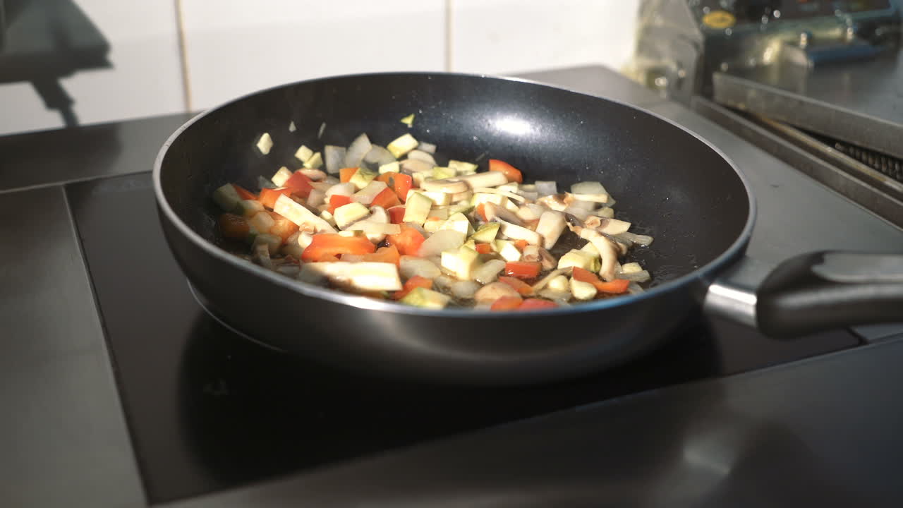 Man cooking vegetable stew. Sliced fresh vegetables in pan with spices and ingredients