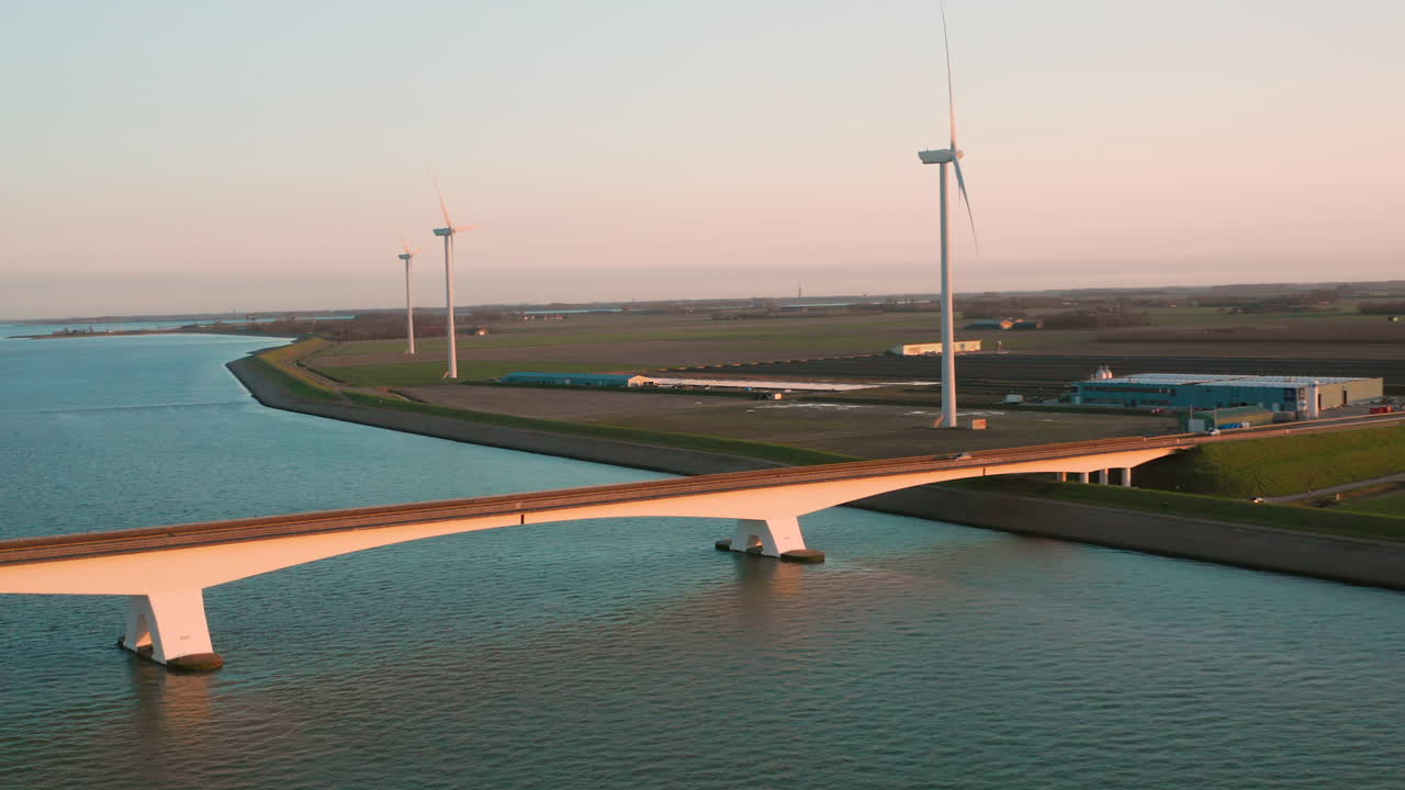 Bridge with Wind Turbines at Sunset