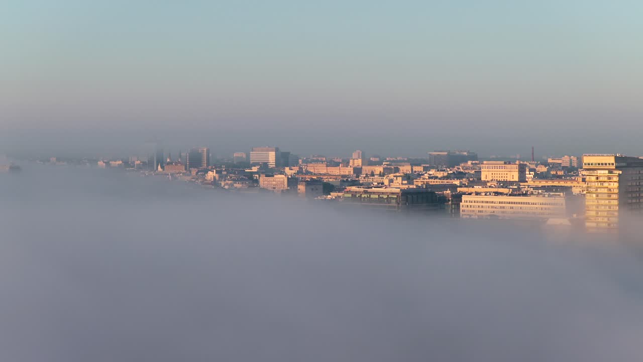 Warsaw's Srodmiescie district shrouded in morning fog at sunrise