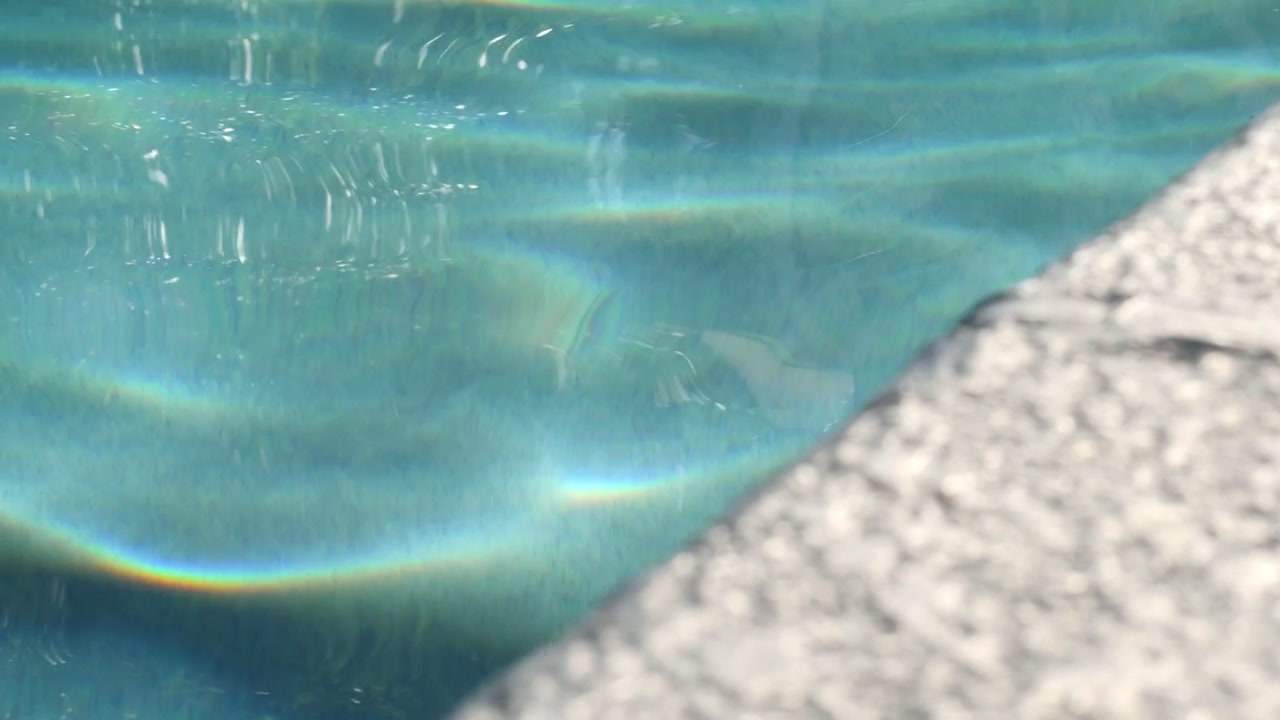 Clear blue pool water rippling, shot in 120 frames per second, 1080p for ultra slow motion.