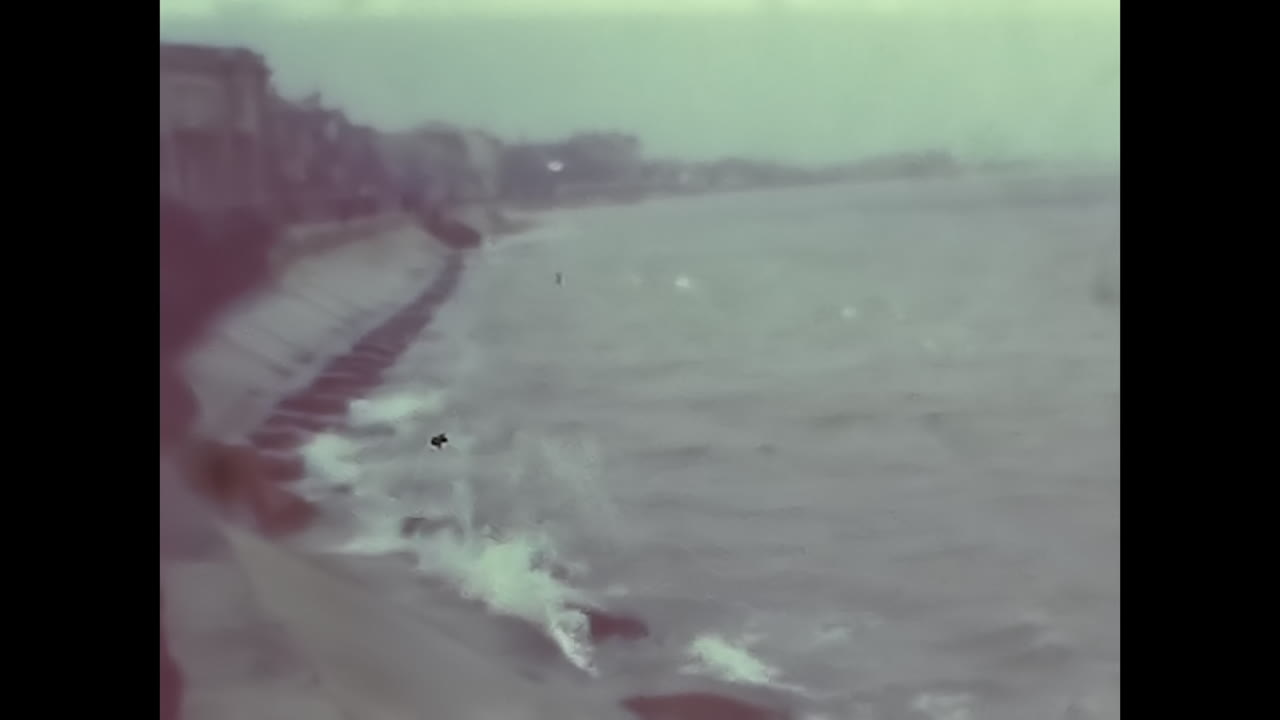 Video of Beach With Crashing Waves, Tranquil Scene of Natures Power. CIRCA USSR 1970: Witness the mesmerizing force of nature as waves crash onto the shore in this blurred beach video.