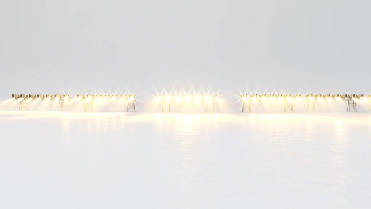 Telecamera che si allontana rivelando tre banchi luci in studio per mostrare l'illuminazione con traliccio, nebbia e pavimento