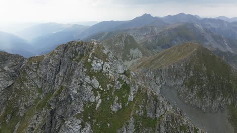 drone orbit around a mountain peak with mountains, a sea and beautiful landscape in the background, carpathians, romania, europe, drone, summer