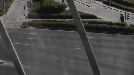 Looking-through-a-window-of-distant-middle-eastern-woman-walking-together-in-downtown-Dubai-during-a-sunny-day