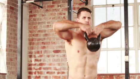 male athlete using a kettlebell