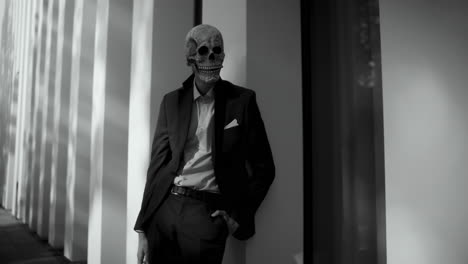 man in a suit with a skull mask