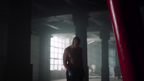 athlete finishing strength exercise. man feeling tired after boxing training