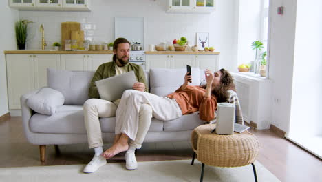 man and woman sititng at living room