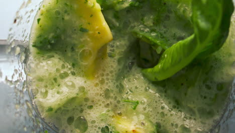 closeup preparing vegetable smoothie in blender bowl super slow motion top view.