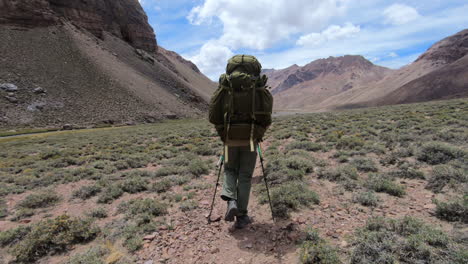 person hiking with heavy backpack on the approach to basecamp on aconcagua