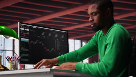vertical video african american man using pc to purchase and sell stocks