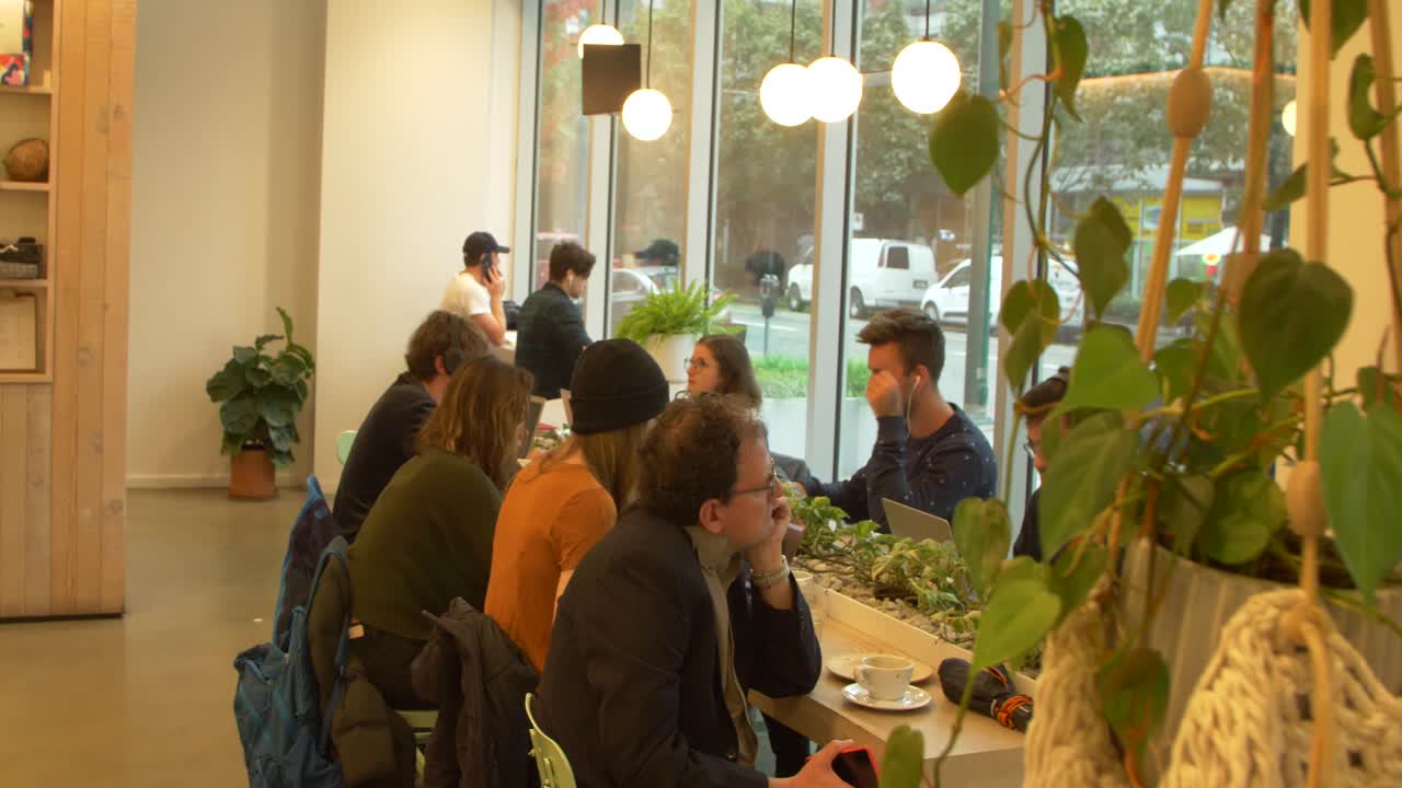 cinematic millenials at coffee shop working on laptop