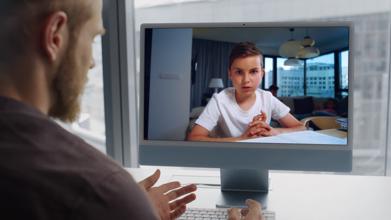 Teacher talking online computer lesson with kid home closeup. Remote education