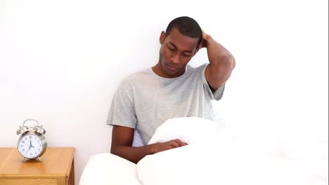 Hungover-man-sitting-in-his-bed