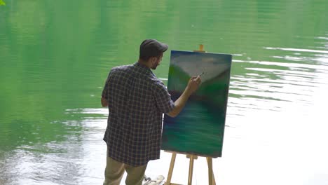 Painter painting by looking at the lake.