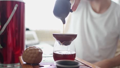 portable table for the tea ceremony. tea is poured into the teapot through a funnel, saturating its taste with oxygen