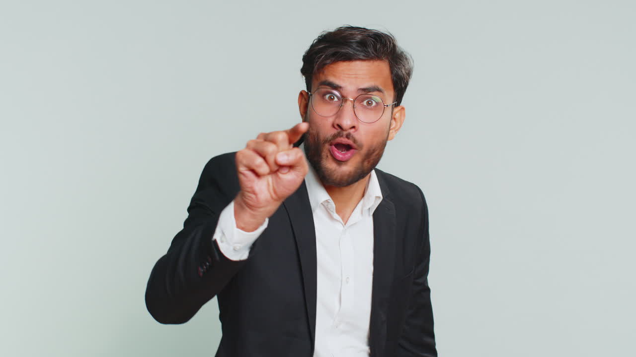 Irritated displeased aggressive unhappy businessman gesturing hands blaming scolding failure problem