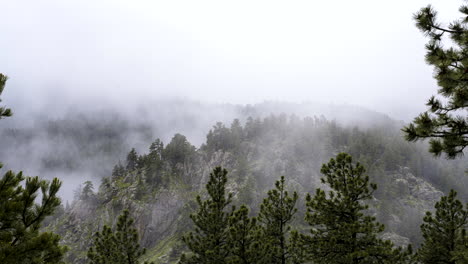 Mountain-fog-swirling-around-Flagstaff-mountainside,-Boulder