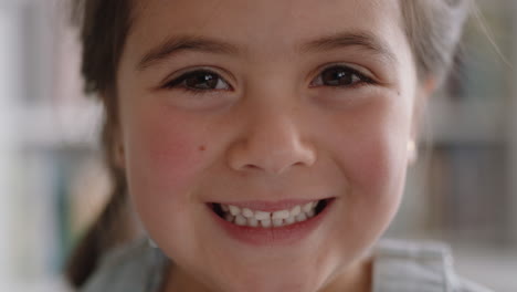 close up portrait beautiful little girl smiling with natural childhood curiosity looking joyful child with innocent playful expression 4k footage