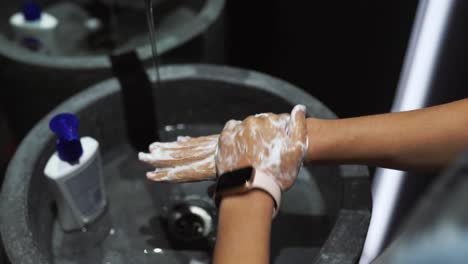 washing hands in a public restroom